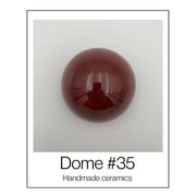 Handgemaakte keramische wandkoepel in roodtinten, diameter per koepel ca. 9.5 cm